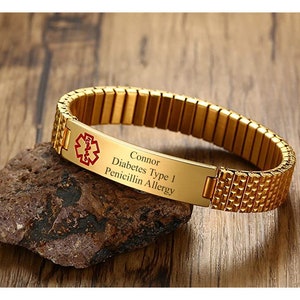 May include: Gold medical alert bracelet with a red medical symbol and the text "Connor Diabetes Type 1 Penicillin Allergy".