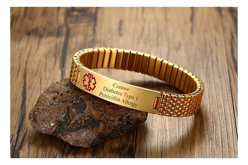 May include: Gold medical alert bracelet with a red medical symbol and the text "Connor Diabetes Type 1 Penicillin Allergy".