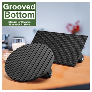 May include: Two black grill presses with grooved bottoms. One is round, the other rectangular. The text in the image reads "Grooved Bottom", "Classic Grill Marks", and "Non-stick Surface".