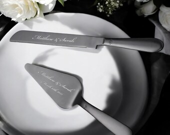 May include: A silver cake knife and server set with the inscription "Matthew & Sarah" and the date "March 18th, 2023".