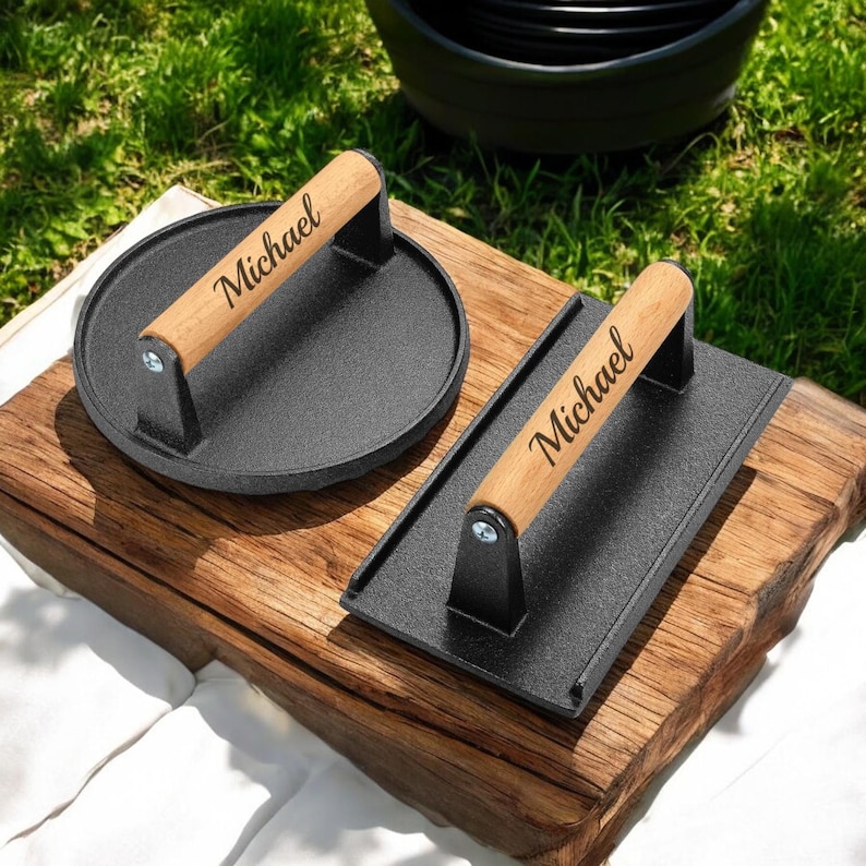 One round and one rectangular black burger press with wooden handles