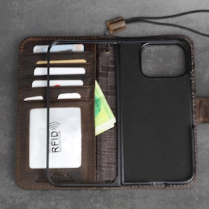 Funda de piel auténtica ARICHI para Apple iPhone 16, 15, 14, 13, 7, 8 Plus, Pro Max SE, estilo libro, con ventana para identificación, ranuras para tarjetas de crédito, inalámbrica