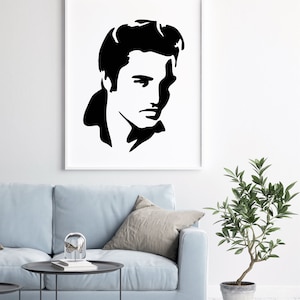 Puede incluir: Impresi&oacute;n en silueta en blanco y negro de la cara de Elvis Presley. La impresi&oacute;n est&aacute; enmarcada y colgada en una pared blanca sobre un sof&aacute; azul claro.