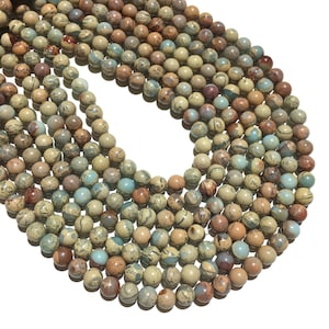 May include: A strand of round, multi-coloured, natural stone beads. The beads are a mix of brown, green, and blue colours with a marbled pattern.