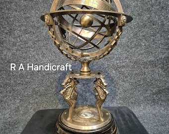 May include: A brass celestial globe on a stand with a compass. The globe is detailed with constellations and zodiac signs. The stand is decorated with ornate animal figures.