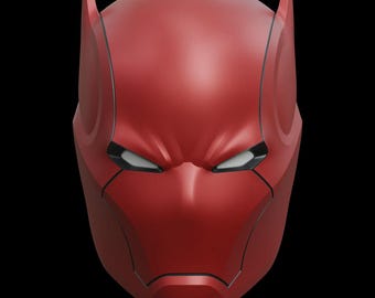 May include: A vibrant red superhero mask with a stern expression. The mask has sharp lines, ear-like points, and white eye openings. The design is reminiscent of a comic book character.