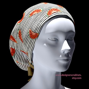 May include: A scrub hat with a black and white striped design, adorned with red watermelon slices. The hat is secured at the back with a brown tie. The website address www.designerscrubhats.etsy.com is printed on the lower right.