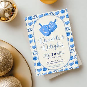 May include: An invitation card with the text "Dreidels & Delights" and event details. The card features blue dreidel illustrations and Star of David symbols on a cream background. Gold and glittery ornaments are in the background.