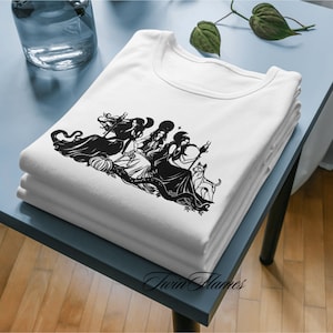 May include: A white t-shirt with a black silhouette of three women with long flowing hair and a cat. The women are wearing long dresses and have a mystical vibe. The text "Twin Flames" is printed on the bottom of the shirt.
