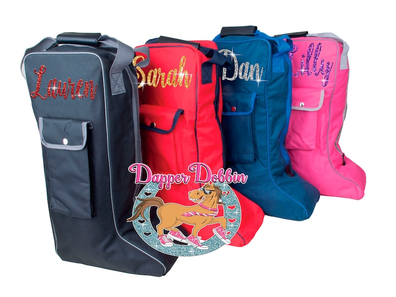 May include: Four boot bags with different colored fabric and personalized names in glitter. The names are "Lauren", "Sarah", "Dan", and "Lilly". The bags are all black with a gray pocket on the front. The bags are arranged in a row from left to right. The bags are all made of a durable fabric and have a zipper closure. The bags are perfect for storing and transporting boots.