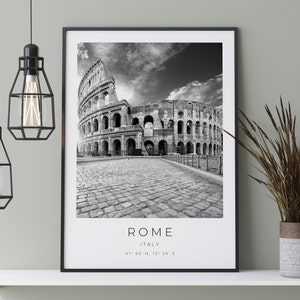 May include: Black and white photograph of the Colosseum in Rome, Italy. The text "ROME" and "ITALY" are printed below the image, along with the coordinates "41&deg; 53' N, 12&deg; 29' E".