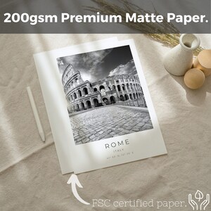 May include: A black and white photograph of the Colosseum in Rome, Italy. The image is printed on 200gsm premium matte paper. The text "ROME" and "ITALY" is printed below the image, along with the coordinates "41&deg; 53&prime; N, 12&deg; 29&prime; E". The text "FSC certified paper." is printed below the image.
