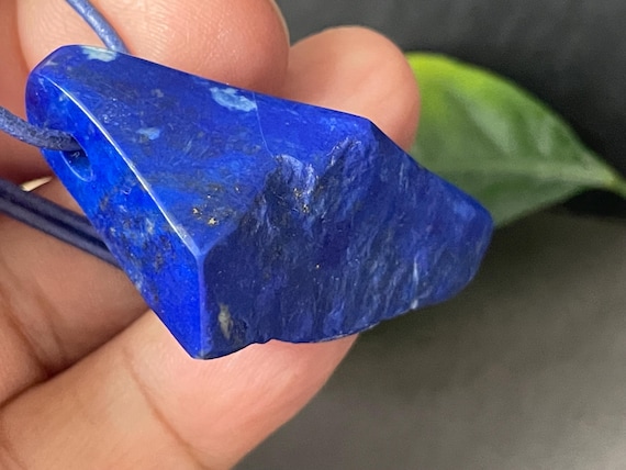 Beautiful drilled lapis lazuli pendant – a unique piece of spiritual gemstone jewelry for intuition, truth, new energy. The magic eye.