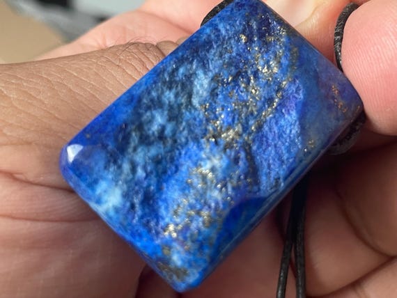 Genuine lapis lazuli pendant drilled in a unique design
