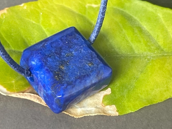 Beautiful drilled lapis lazuli pendant – a unique piece of spiritual gemstone jewelry for intuition, truth, new energy. The magic eye.