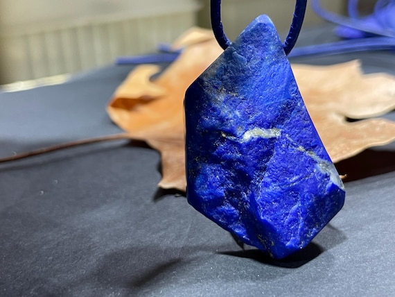 Beautiful drilled lapis lazuli pendant – a unique piece of spiritual gemstone jewelry for intuition, truth, new energy. The magic eye.