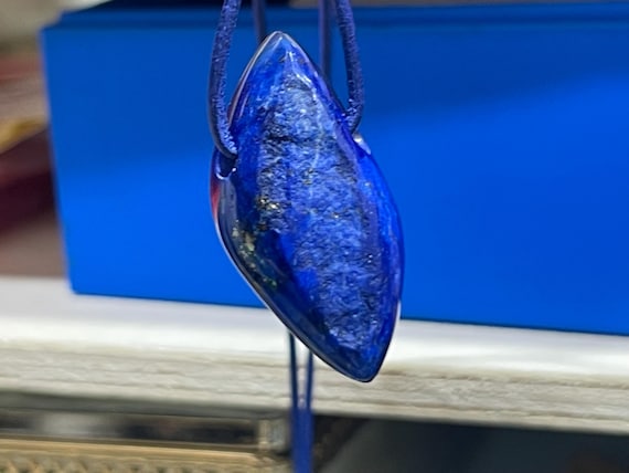 Beautiful drilled lapis lazuli pendant – a unique piece of spiritual gemstone jewelry for intuition, truth, new energy. The magic eye.