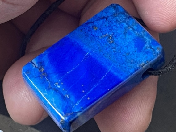Genuine lapis lazuli pendant drilled in a unique design, natural color