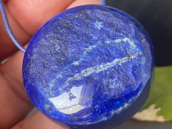 A rather large, beautiful, drilled lapis lazuli pendant – a unique piece of spiritual gemstone jewelry for intuition, truth, and new energy.