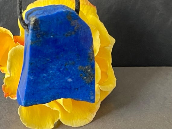Genuine lapis lazuli pendant drilled in a unique design