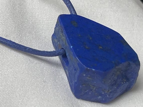 Beautiful drilled lapis lazuli pendant – a unique piece of spiritual gemstone jewelry for intuition, truth, new energy. The magic eye.