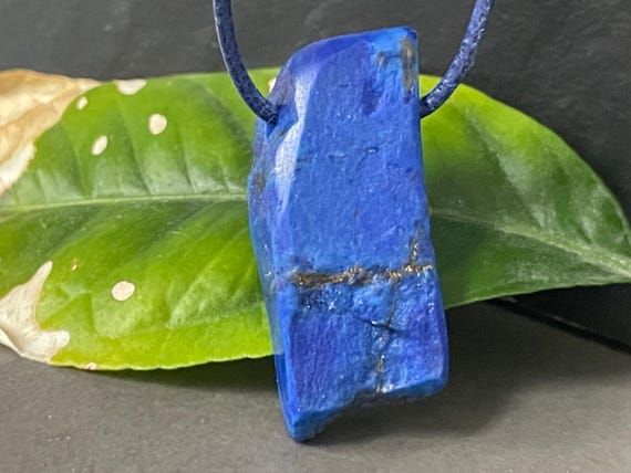 Beautiful drilled lapis lazuli pendant – a unique piece of spiritual gemstone jewelry for intuition, truth, new energy. The magic eye.