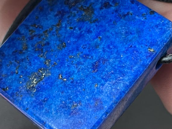 Genuine lapis lazuli pendant drilled in a special way and left natural