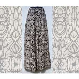 May include: Wide-leg trousers with a black waistband and a black and white patterned design.
