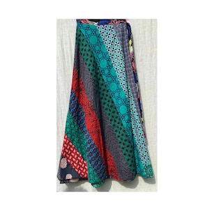 May include: A colorful wrap skirt with a patchwork design featuring various geometric patterns in shades of blue, green, red, and black.