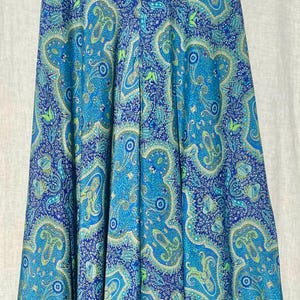 May include: A blue and green paisley patterned skirt with a high waist and a flowing silhouette.