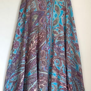 May include: A blue and purple paisley patterned skirt with a flared silhouette.