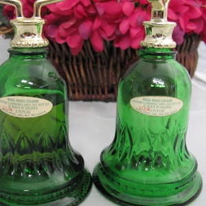 May include: Two green glass bell-shaped bottles with gold tops and labels that read "Roses Roses Cologne" and "Caution Flammable Until Dry Keep Out of Reach of Children 3/75 Fl.Oz. Avon Prod. Inc. N.Y. N.Y. 10019"