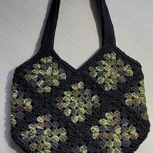 May include: A black crocheted tote bag with green, brown, and gray granny squares.