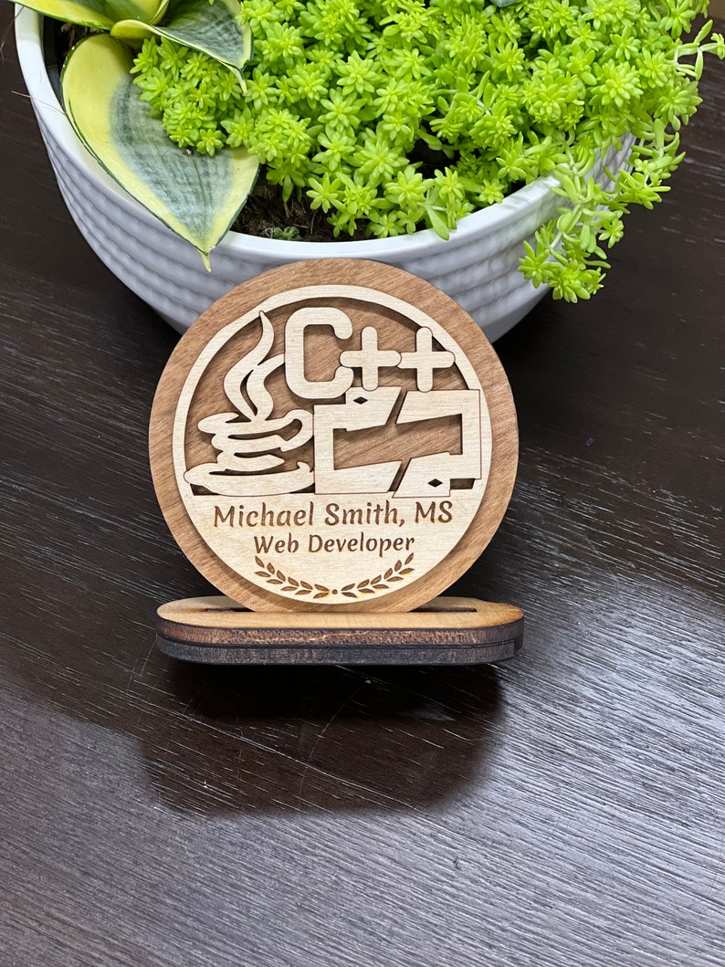 May include: A wooden award plaque with a stylized image of a computer monitor, a coffee cup, and the text "C++". The plaque also includes the text "Michael Smith, MS Web Developer" and a laurel wreath.