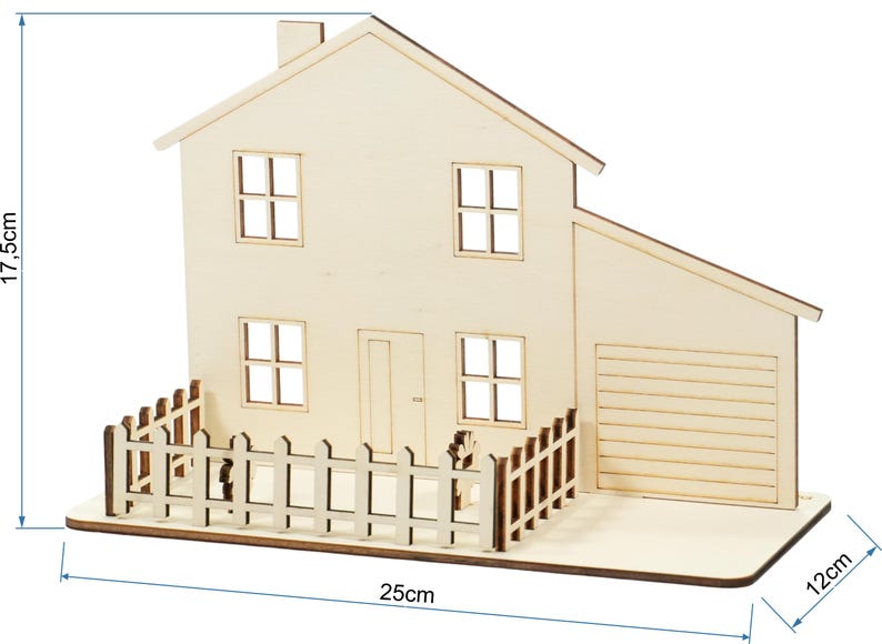 May include: A light-colored wooden house model featuring a front door, four windows, and an attached garage. A picket fence surrounds the front yard area. The structure measures 17.5 cm in height, 25 cm in width, and 12 cm in depth as indicated.