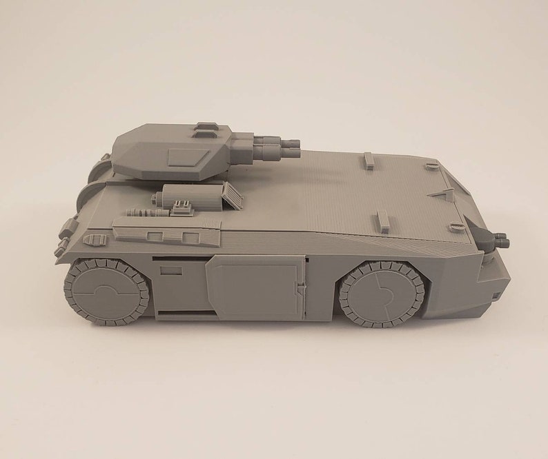 APC model with movable top turret and sliding door.