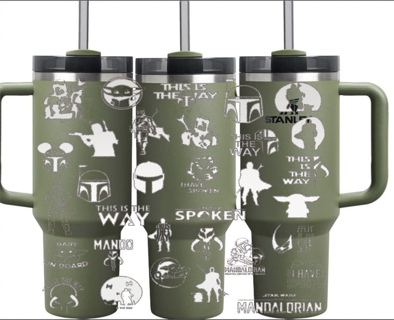 Puede incluir: Tres vasos Stanley verde oliva con tapas y asas negras. Cada vaso presenta gr&aacute;ficos y texto blancos de la serie Star Wars, incluyendo personajes y frases como "This is the Way" y "Mandalorian."