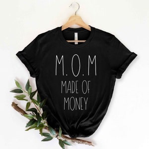 May include: Black t-shirt with white text that reads "M.O.M. Made of Money"