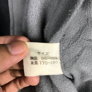 May include: A white tag with black text that reads "サイズ" (Size) and lists the measurements "胸囲 96～104" (Chest 96-104 cm) and "身長 170～180" (Height 170-180 cm).