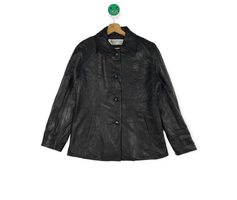 May include: A black leather jacket with a button-up front and a label that reads "Armin" on the inside collar.