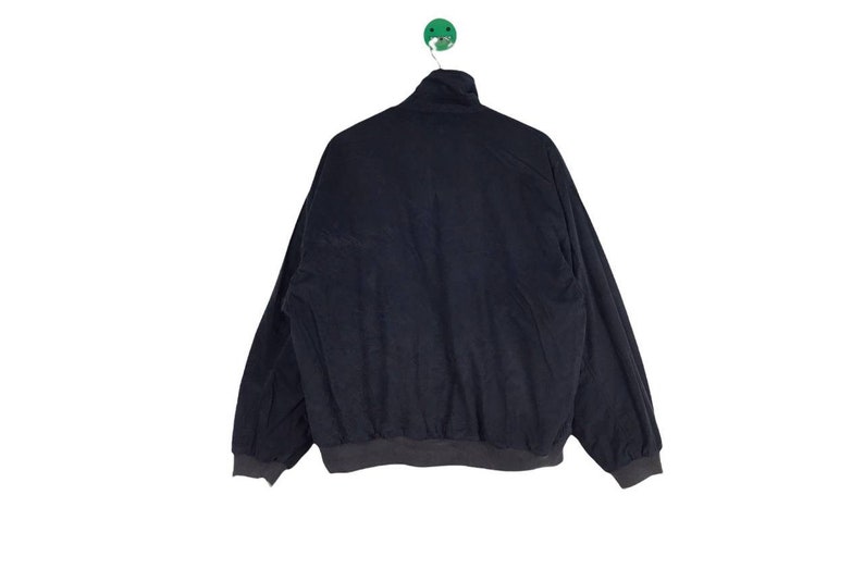 May include: A dark blue corduroy jacket with a zipper closure and a ribbed collar and cuffs.