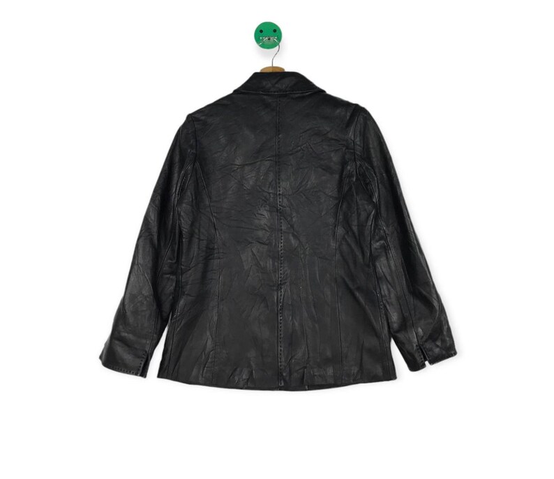 May include: A black leather jacket with a classic design. The jacket has a collar, long sleeves, and a button closure.
