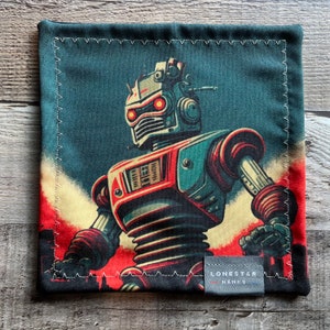 May include: Square, dark teal handkerchief featuring a retro robot illustration in red, teal, and cream colors. The robot has glowing red eyes and is set against a dark teal and red background. The handkerchief has a stitched border and a small label that reads "LONESTAR HANKS".