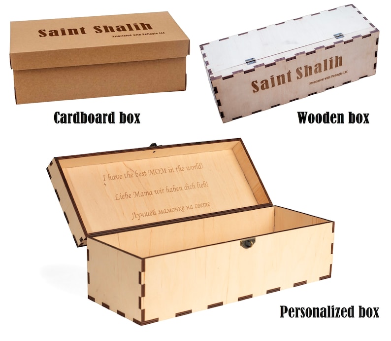 May include: Three boxes are shown: a brown cardboard box, a light-colored wooden box, and a personalized wooden box. The cardboard box and wooden box have the text "Saint Shalih" on them. The personalized box has text inside.