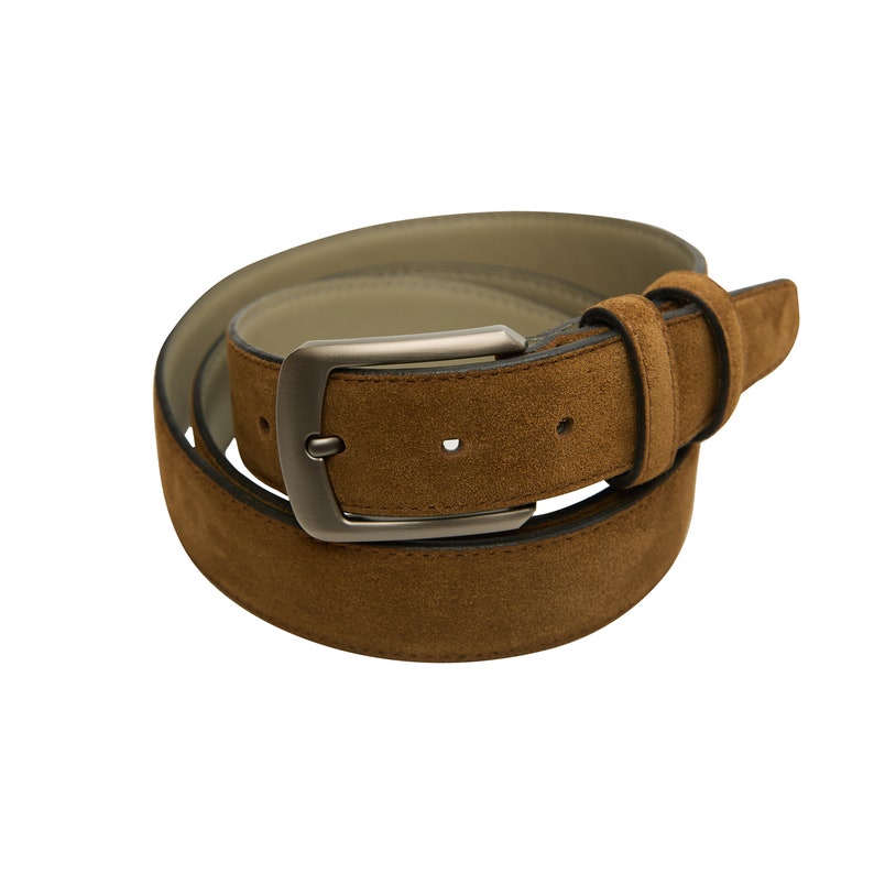 May include: A brown suede belt with a silver buckle. The belt is rolled up and the buckle is visible.