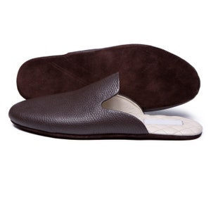 May include: Brown leather slippers with a suede insole and a white quilted lining.