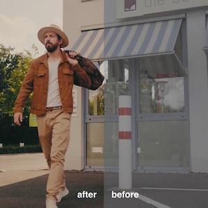 May include: A man wearing a brown jacket, a white t-shirt, beige pants, and a white hat walks away from a building with a striped awning. He is carrying a brown bag over his shoulder.