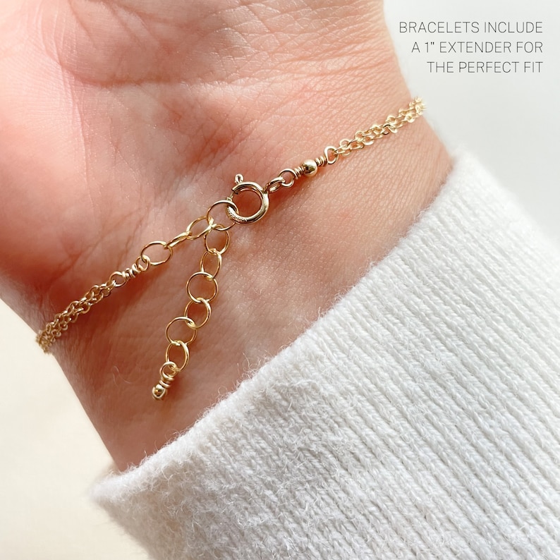 May include: Gold chain bracelet with a lobster clasp and an extender chain. The text "BRACELETS INCLUDE A 1" EXTENDER FOR THE PERFECT FIT" is visible in the image.