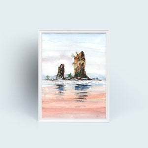 May include: Watercolour painting of two sea stacks in a white frame. The artwork shows a tranquil coastal scene with soft colours, including pink, blue, and brown. The water reflects the sky and the rocks.