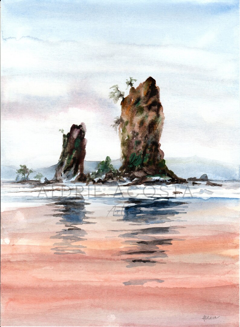 May include: Watercolor painting of a coastal scene featuring two large, dark rock formations rising from the water. The water reflects the sky and the rocks, with a sandy beach in the foreground. The artist's signature is visible.